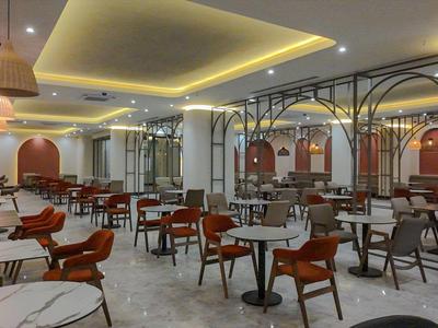 Modern dining area with elegant design and wooden furniture in warm lighting.