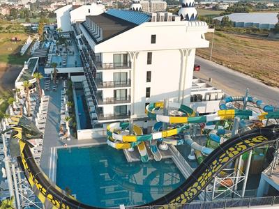 Modern holiday resort with water slides and outdoor pool in a rural setting.