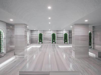 Grande salle de bien-être lumineuse avec murs en marbre et niches décorées.