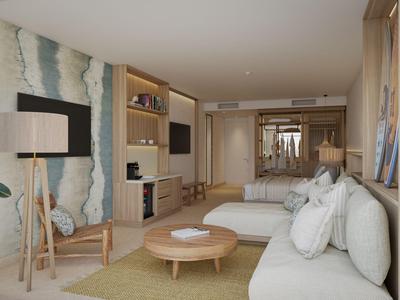 Modern eingerichtetes Hotelzimmer mit Sofa, Couchtisch und Fernseher.