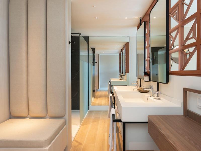 Moderner heller Flur mit Sitzbank, großen Spiegeln und Holz- sowie weißen Elemente.