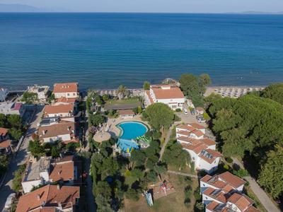 Aerial view of holiday homes with pool and sea view.