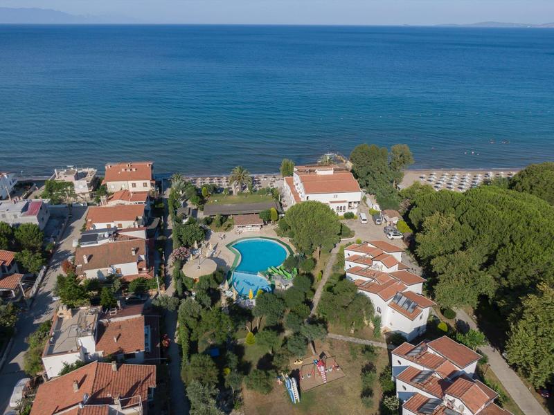 Aerial view of holiday homes with pool and sea view.