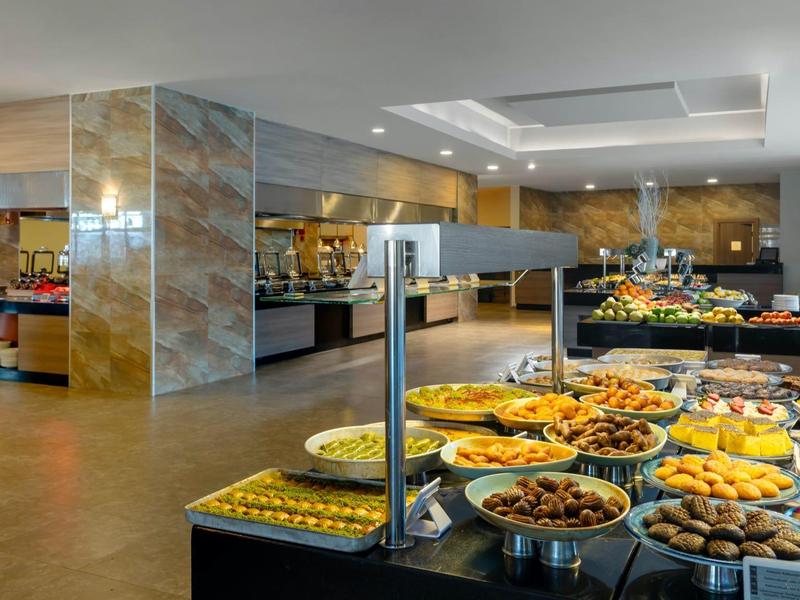 Buffet setup with various dishes in a spacious, well-lit dining area.