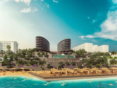 Resort sulla spiaggia di lusso con edifici moderni e lettini sulla spiaggia sabbiosa.