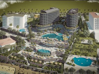 Vista aerea di un complesso turistico con più edifici, piscine e aree paesaggistiche.