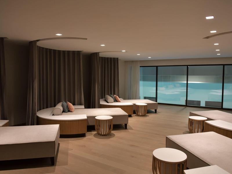 Modern, stylish lounge room with large windows and sea view.