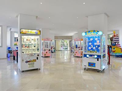 Helle und geräumige Spielhalle mit verschiedenen Spielautomaten und großen Fenstern.