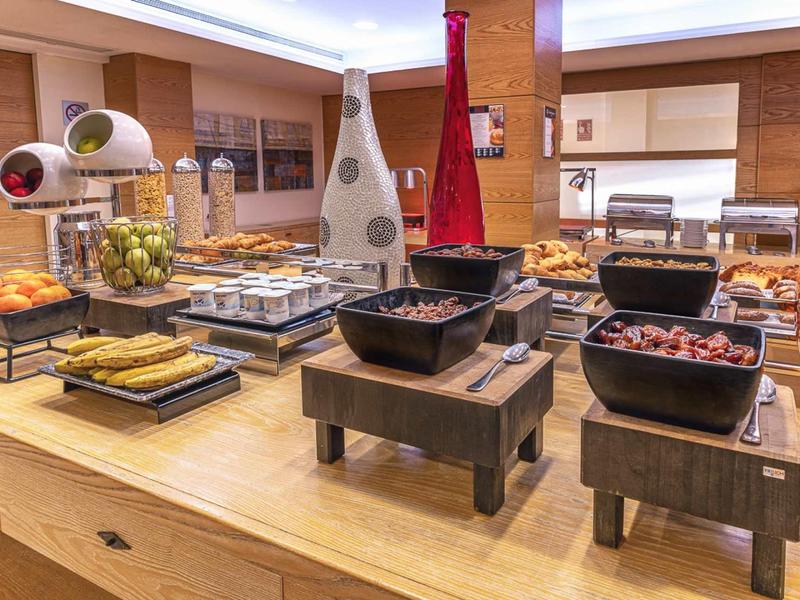 Buffet with various dishes and fresh fruit in a modern restaurant