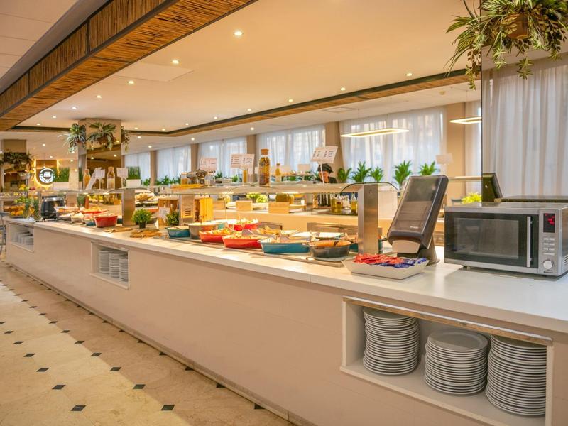 A spacious buffet with a variety of food in a bright dining area.