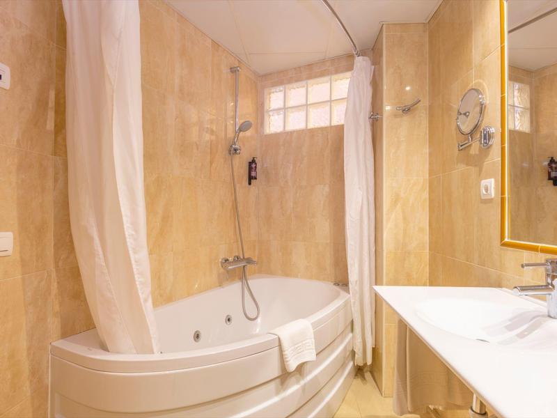 Modern bathroom with bathtub, shower, and white sink