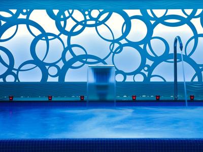 Modern pool area with an artistic blue background window.