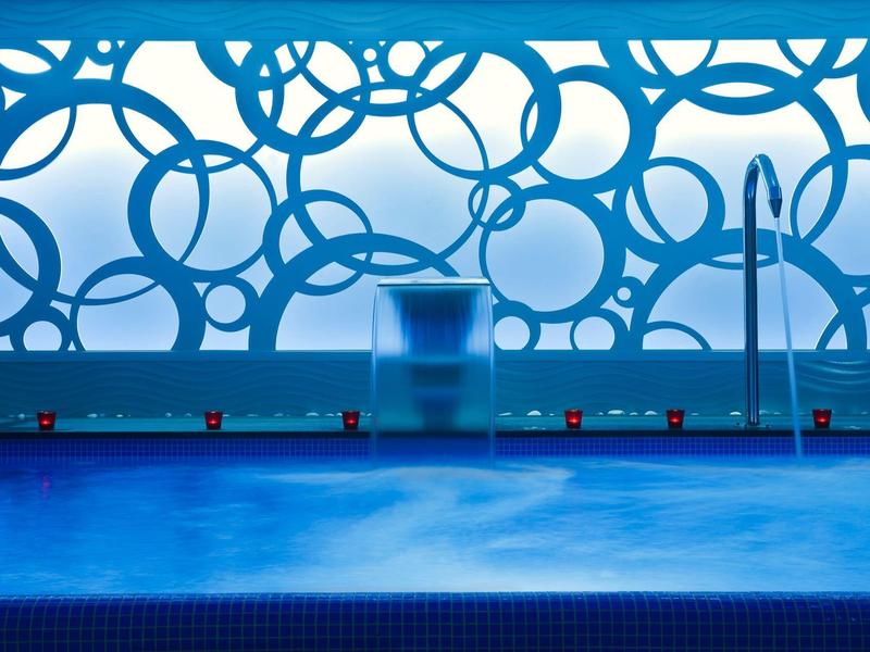 Modern pool area with an artistic blue background window.