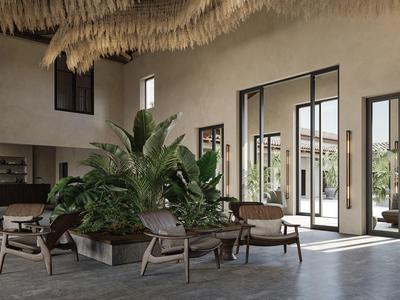 Zona de descanso de hotel iluminada con isla de plantas y mobiliario moderno.