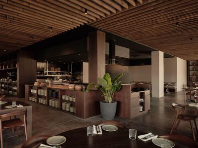 Ristorante moderno in hotel con mobili in legno e una grande pianta al centro.