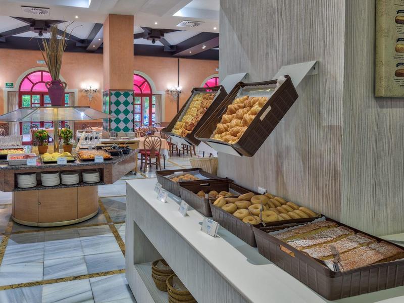 Buffet mit Gebäck, Keksen und Marmeladen in hellem, modernem Frühstücksraum.