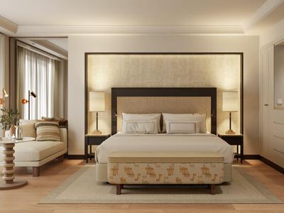 Elegantes Schlafzimmer mit großem Bett, Sitzbereich und warmem Licht