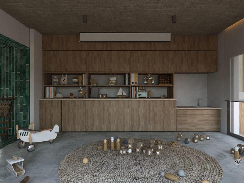 Großer Raum mit Holzregalen, grün gefliestem Kamin und zwei Personen auf Holzboden mit Teppich.