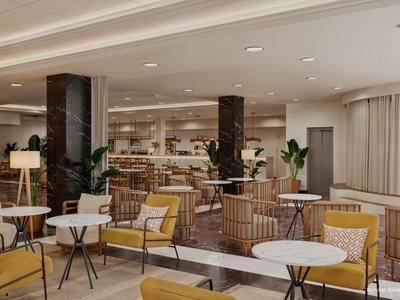 Moderna hall dell'hotel con comode poltrone, tavoli rotondi e illuminazione discreta.