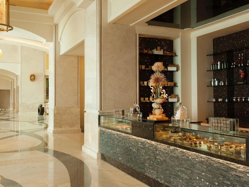 Eleganter Hotel-Lobbybereich mit Marmorfußboden und Empfangstheke mit Dekoration.