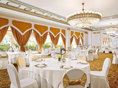 Modern hotel room with double bed, balcony, and sea view.