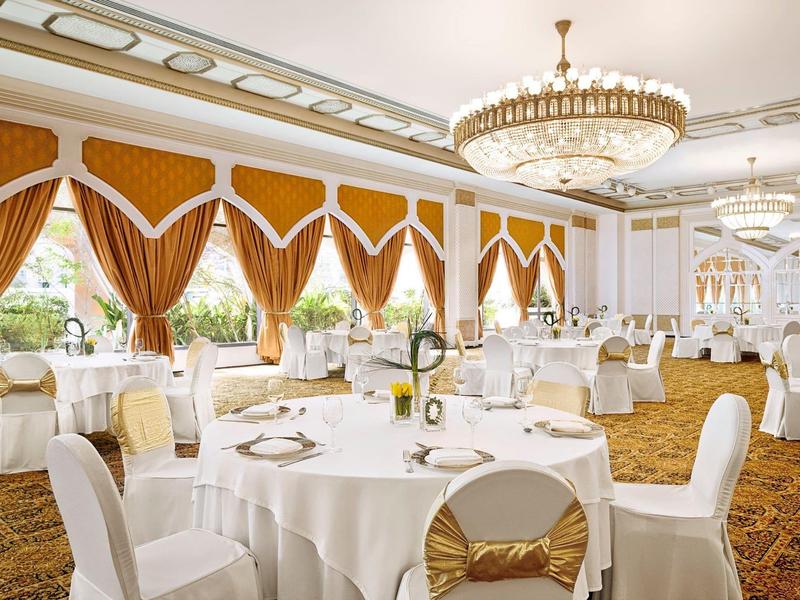 Modern hotel room with double bed, balcony, and sea view.