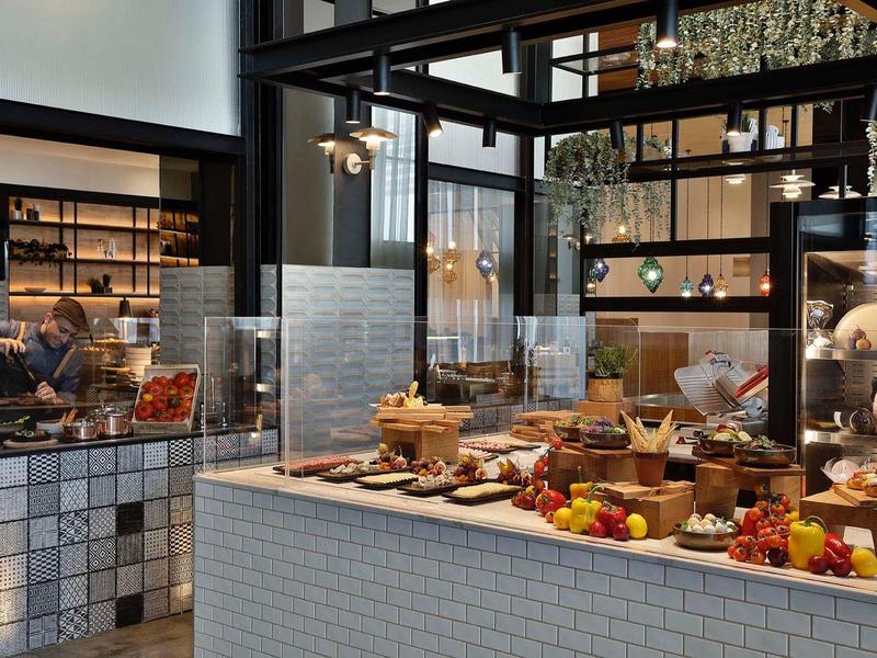 Buffet area with a variety of foods and pastries in a modern restaurant