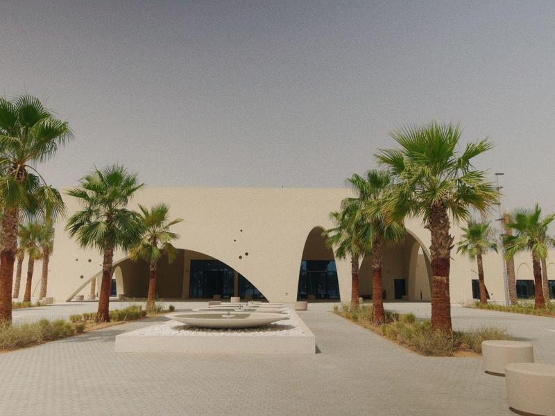 Modernes Gebäude mit großen Bogenfenstern, umgeben von Palmen und einer klaren Wegeführung.