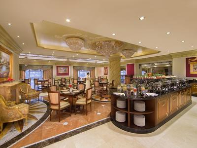 Eleganter Hotel-Lobbybereich mit Sitzgruppen, dekorativen Säulen und Beleuchtung.