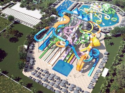 Großer Wasserpark mit mehreren bunten Wasserrutschen, Schwimmbecken und Liegestühlen im Freien.