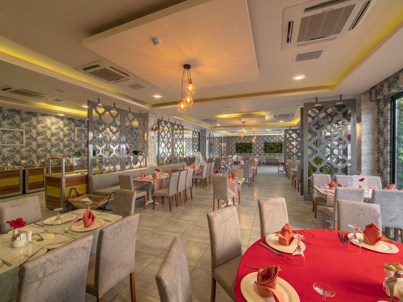 Ristorante elegante dell'hotel con arredamento moderno e tavoli apparecchiati per una cena raffinata.