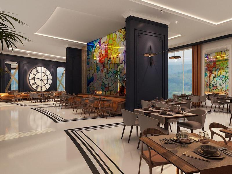 Sala da pranzo moderna dell'hotel con tavoli in legno, sedie, arte murale colorata e grandi finestre.