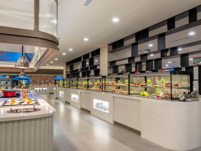 Bright buffet with a selection of dishes and modern decor in the hotel restaurant.