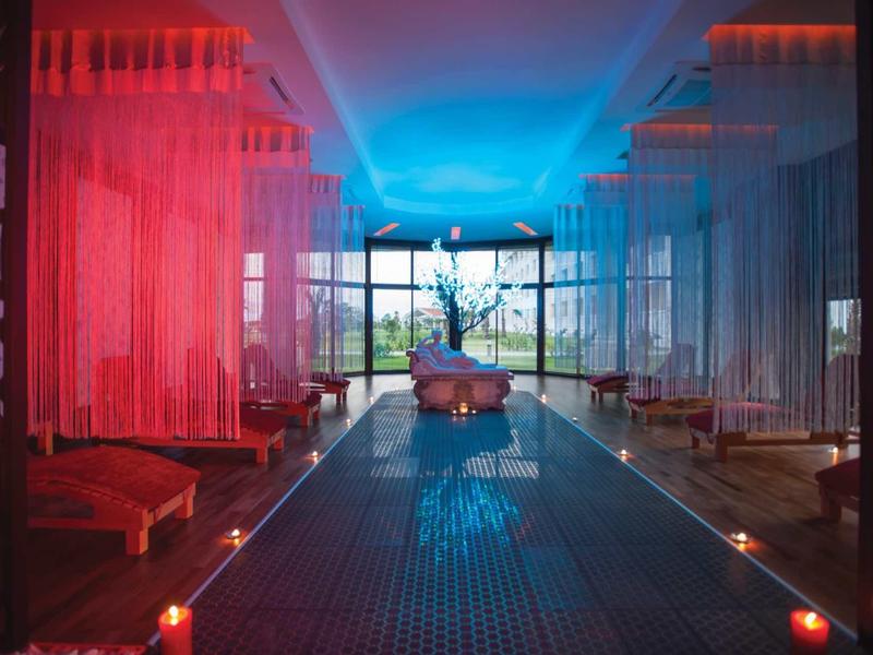 Modern spa area with illuminated pool and relaxing atmosphere at dusk.