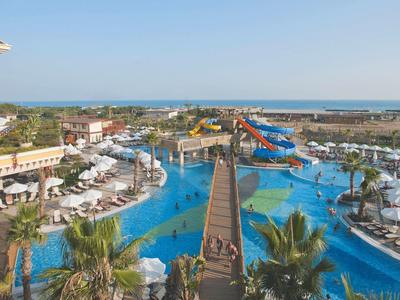 Grande resort con parco acquatico, piscine, scivoli d'acqua e lettini vicino al mare