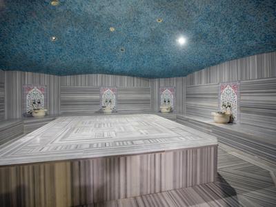 Tradizionale hammam turco con letti in marmo e soffitto decorativo.