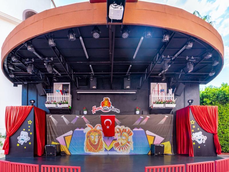 Stage with red curtains and decorative elements at a leisure hotel