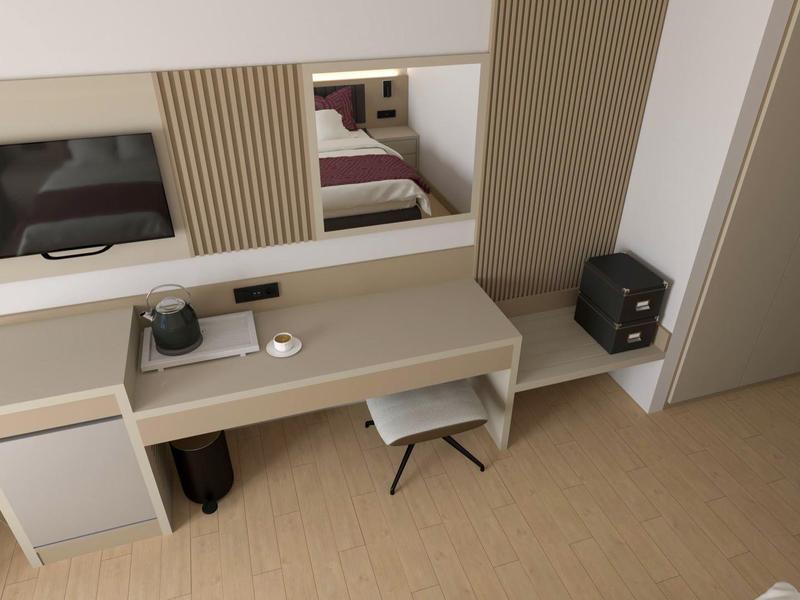 Modern desk with mirror in a hotel room, equipped with minibar and seating.