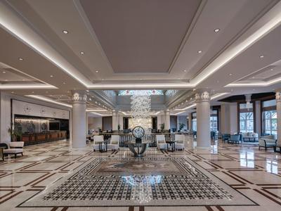 Spacious, elegant hotel lobby with marble floors and modern lighting.