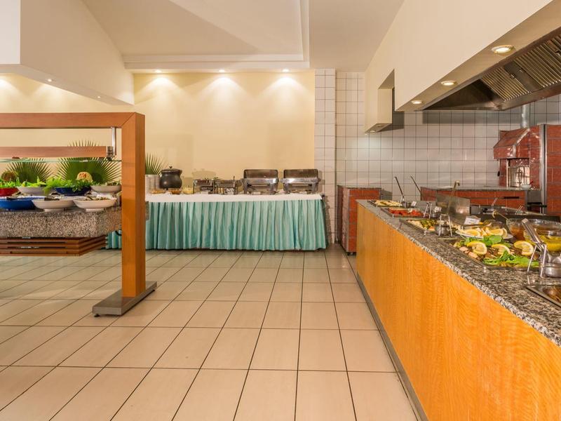 Buffet area with various dishes in a bright, modern hotel restaurant.