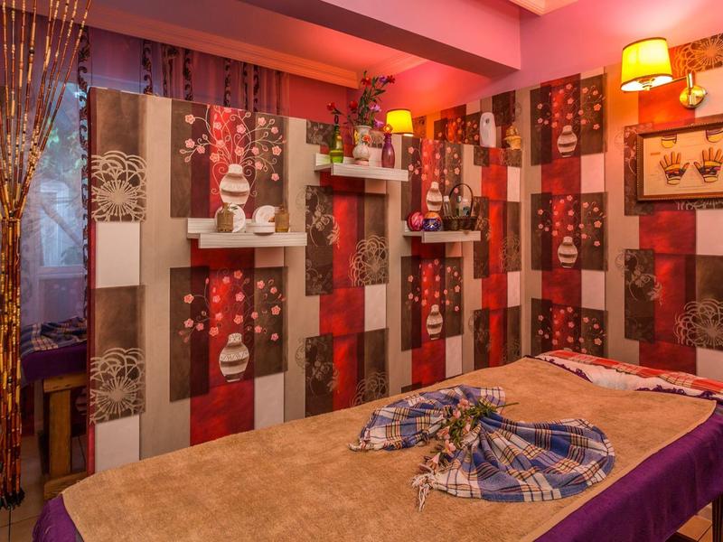 Cozy relaxation room with decorative walls and relaxing massage beds.