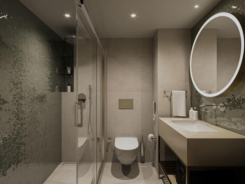 Modern bathroom with walk-in shower, wall-mounted toilet, and illuminated round mirror.