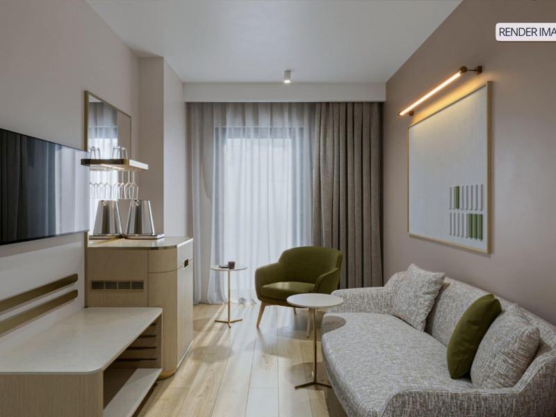 Modern hotel room with sofa, TV, and large window with curtains.