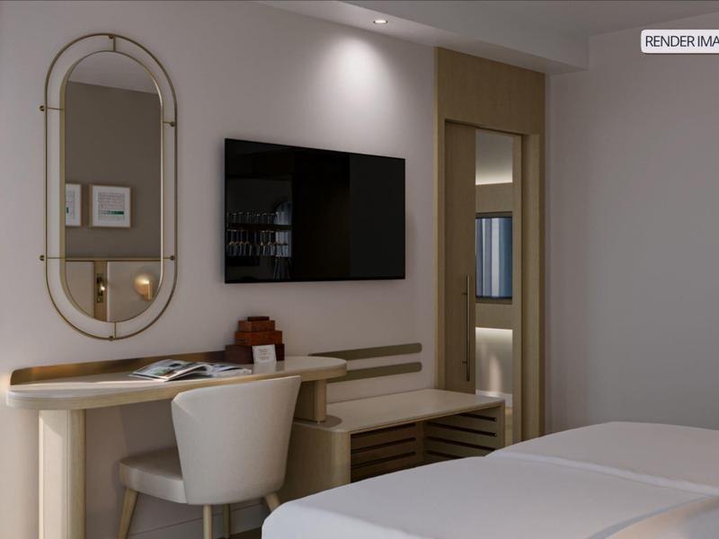 Modern hotel room with desk, TV, mirror, and two beds.