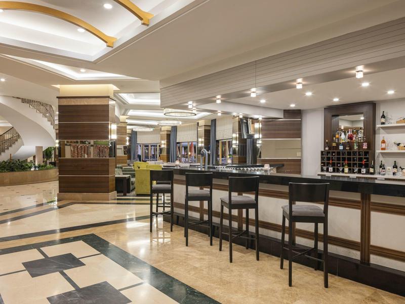 Moderner Hotelbarbereich mit hohen Stühlen und luxuriösem Interieur.