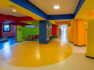 Colorful modern hotel interior with seating areas and plenty of natural light.