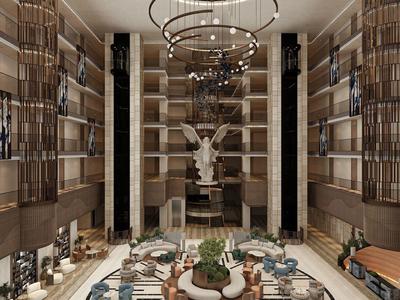 Amplio y lujoso vestíbulo de hotel con paredes altas, candelabros y estatua decorativa en el centro.