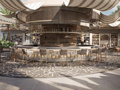 Área de bar de hotel moderno con barra redonda, taburetes y iluminación colgante bajo sombra ligera.