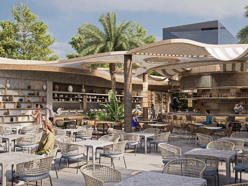 Área exterior moderna de una cafetería con mesas y sillas blancas, palmeras y cielo azul.