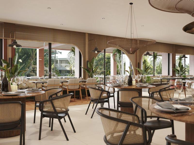 Restaurante luminoso con mesas de madera, sillas negras y grandes ventanas con vistas a áreas verdes.